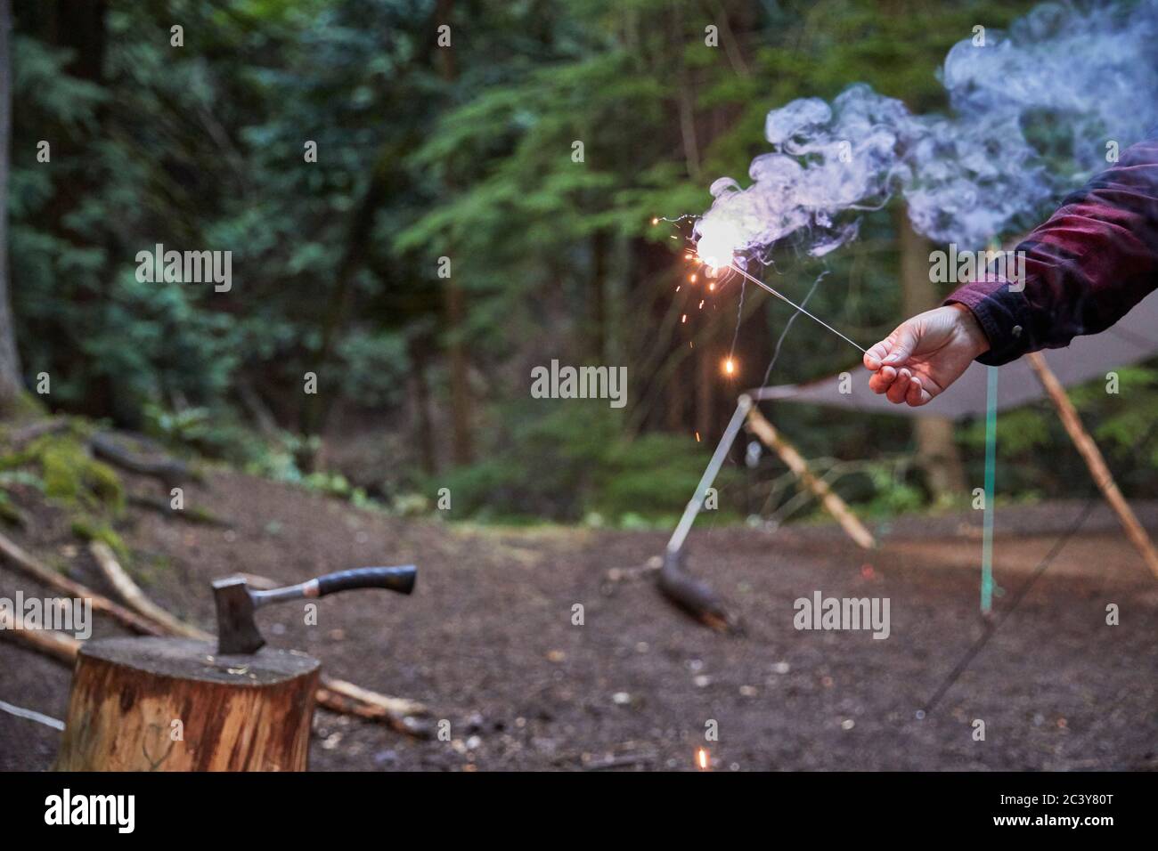Orcas Island, Man holding sparkler at camping Stock Photo