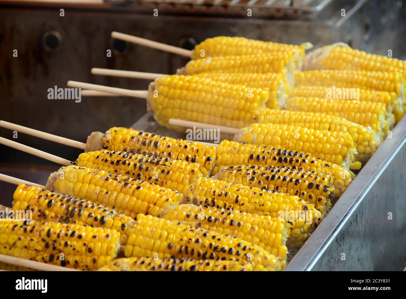 Grilled sweet corn in street food style. Street food snack style in temple festival in Japan. Stock Photo