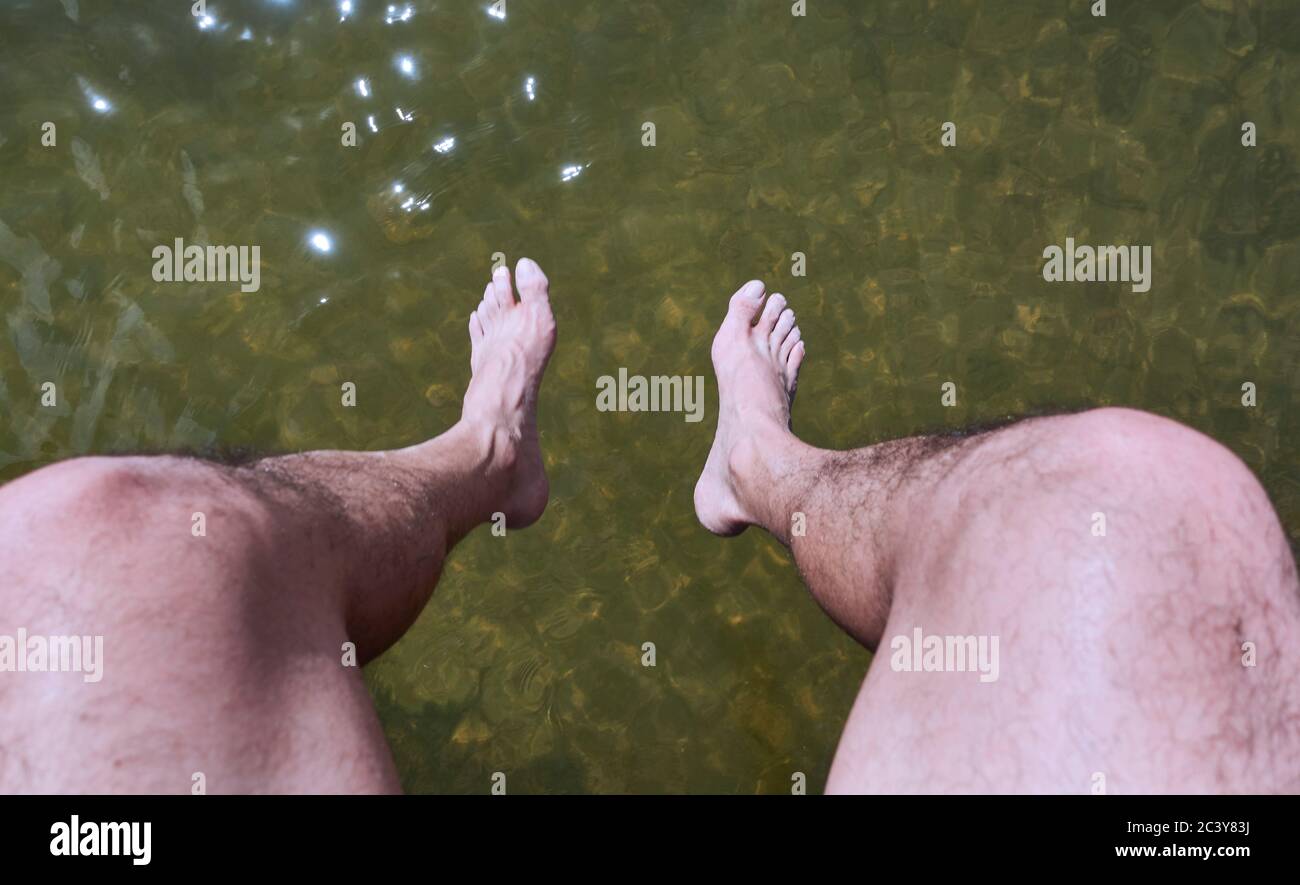 Man sitting above water Stock Photo