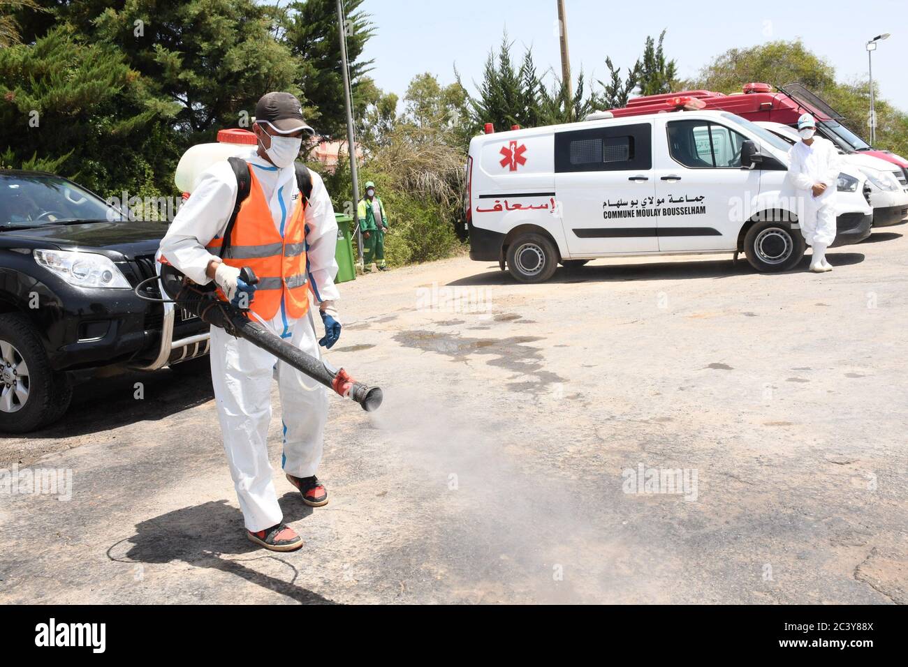 Moulay Bousselham, Morocco. 22nd June, 2020. A medical worker disinfects a parking lot in Moulay Bousselham, Morocco, on June 22, 2020. A total of 195 new COVID-19 cases were confirmed in Morocco on Monday, bringing the total number of coronavirus cases in the country to 10,172. Credit: Chadi/Xinhua/Alamy Live News Stock Photo