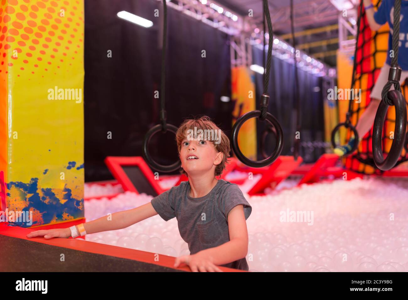 Boy doing an indoor obstacle course Stock Photo