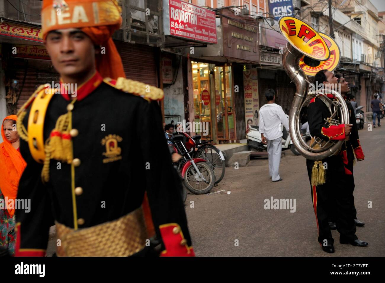 Members of a musical ensemble coordinating on a street in Jaipur, Rajasthan, India. Stock Photo