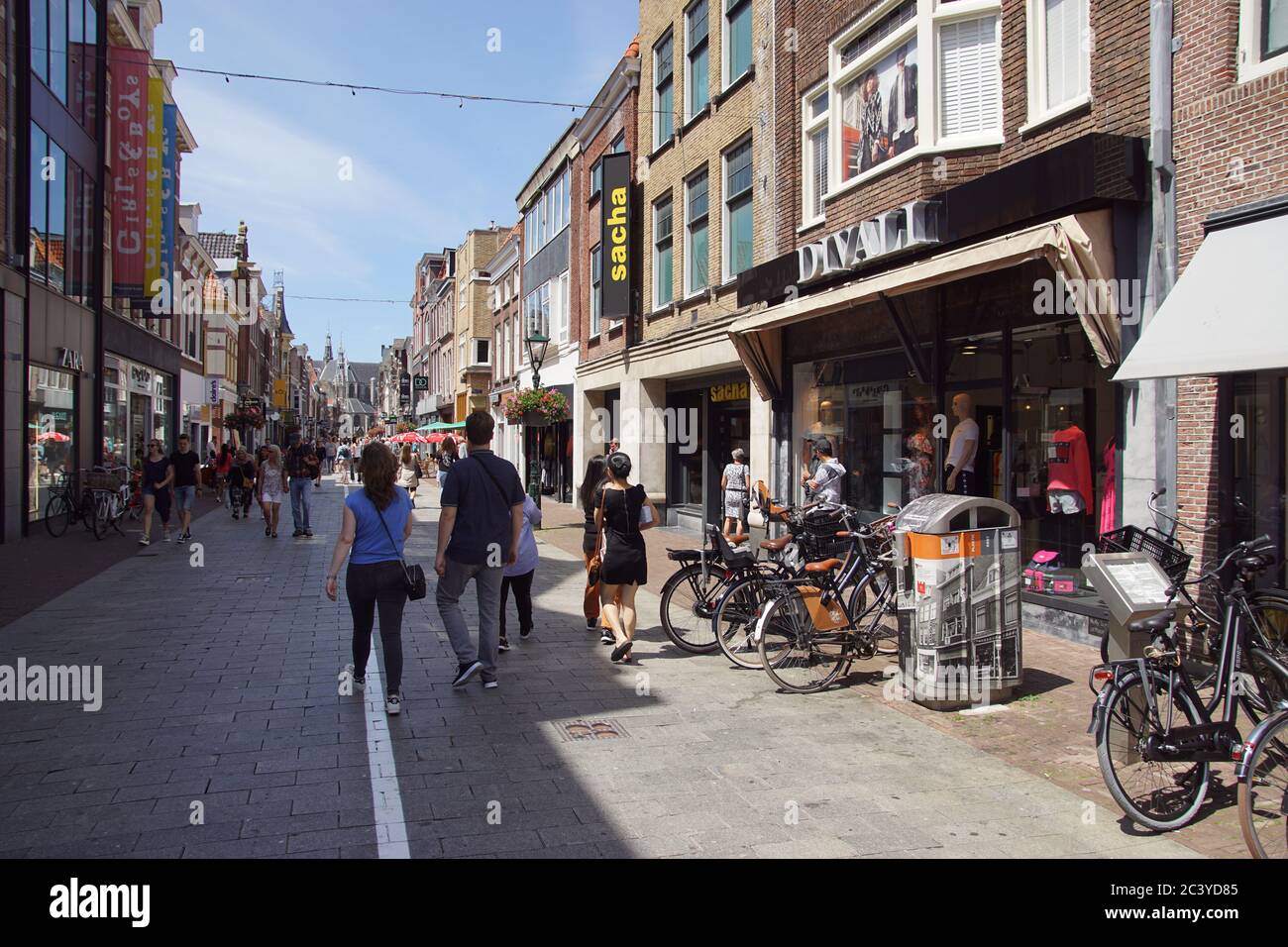 Shopping street (Lange straat) in the Dutch city of Alkmaar. A white line  to separate because of the coronavirus. Large church in the distance Stock  Photo - Alamy