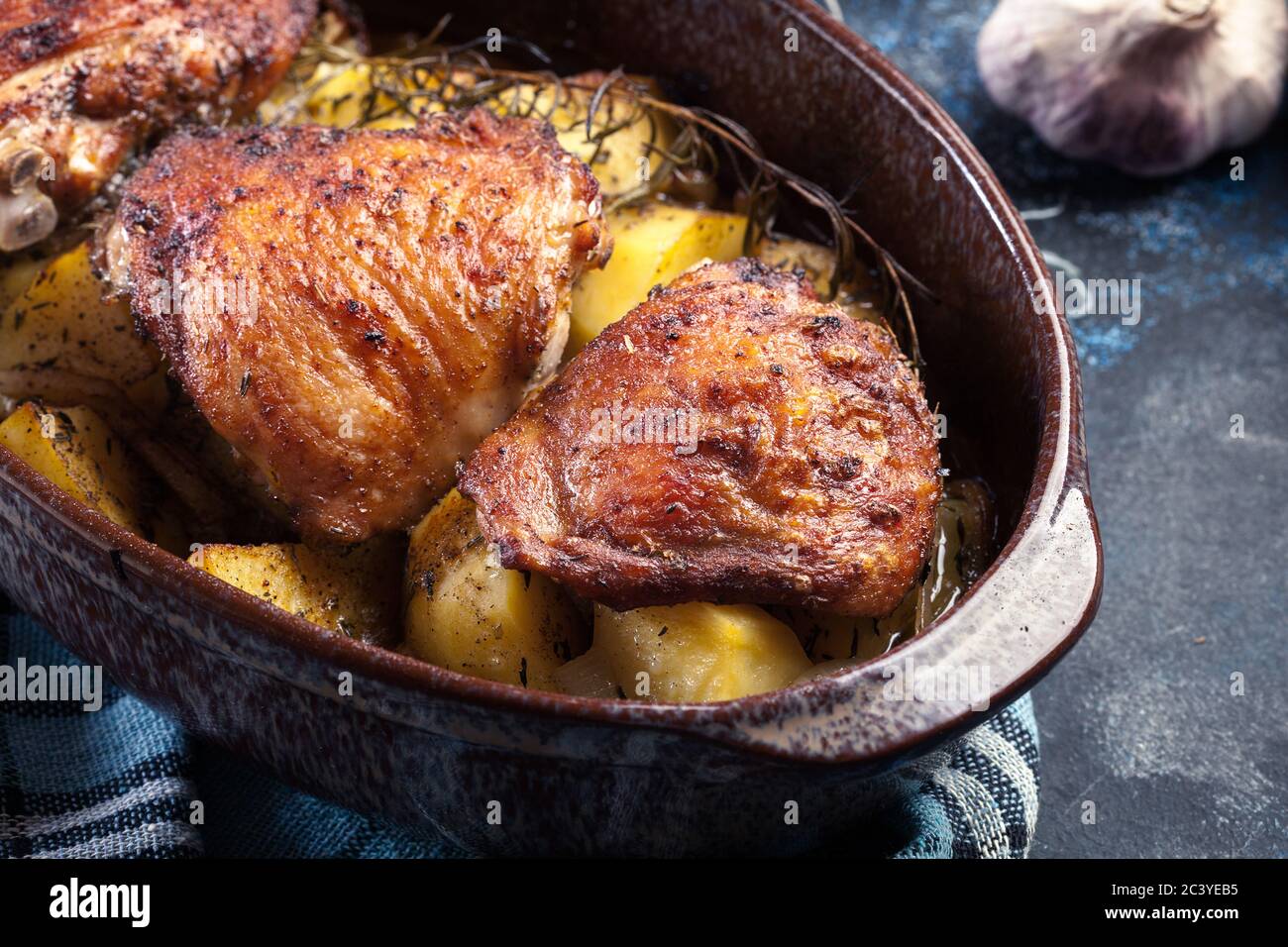 Roasted chicken thighs and potatoes in casserole dish Stock Photo Alamy