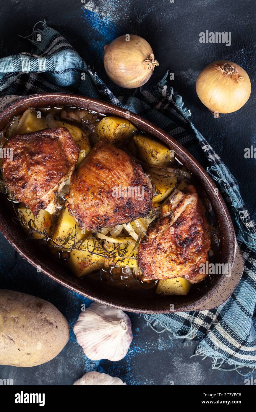 Roasted chicken thighs and potatoes in casserole dish Stock Photo Alamy