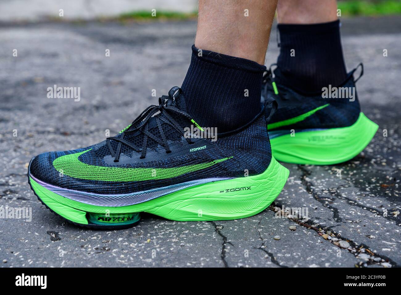 ROME, ITALY, JUNE 23. 2020: Nike running shoes ALPHAFLY NEXT%.  Controversial green athletics shoe on legs of professional athlete running  on the road Stock Photo - Alamy