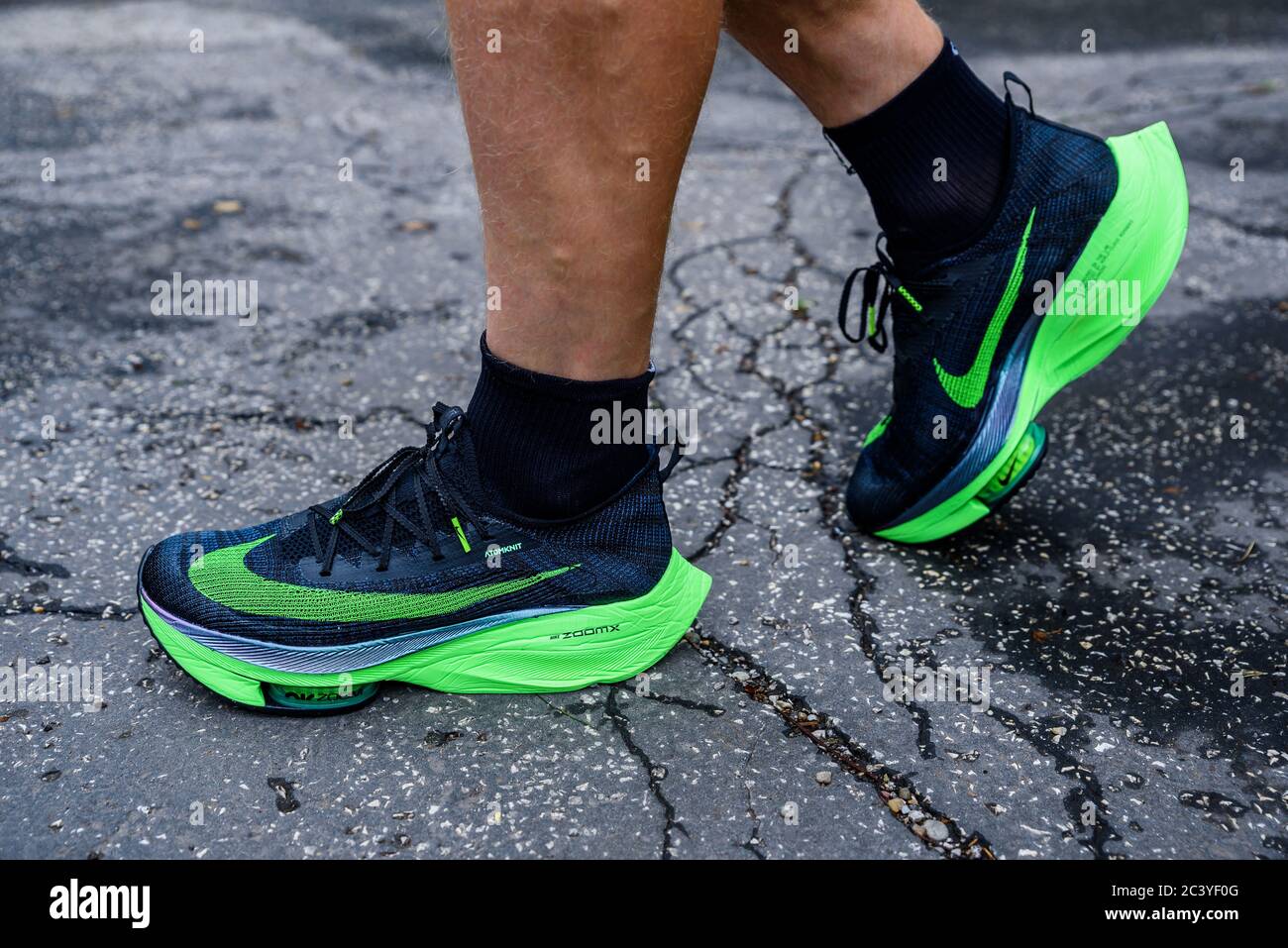 ROME, ITALY, JUNE 23. 2020: Nike running shoes ALPHAFLY NEXT%.  Controversial green athletics shoe on legs of professional athlete running  on the road Stock Photo - Alamy