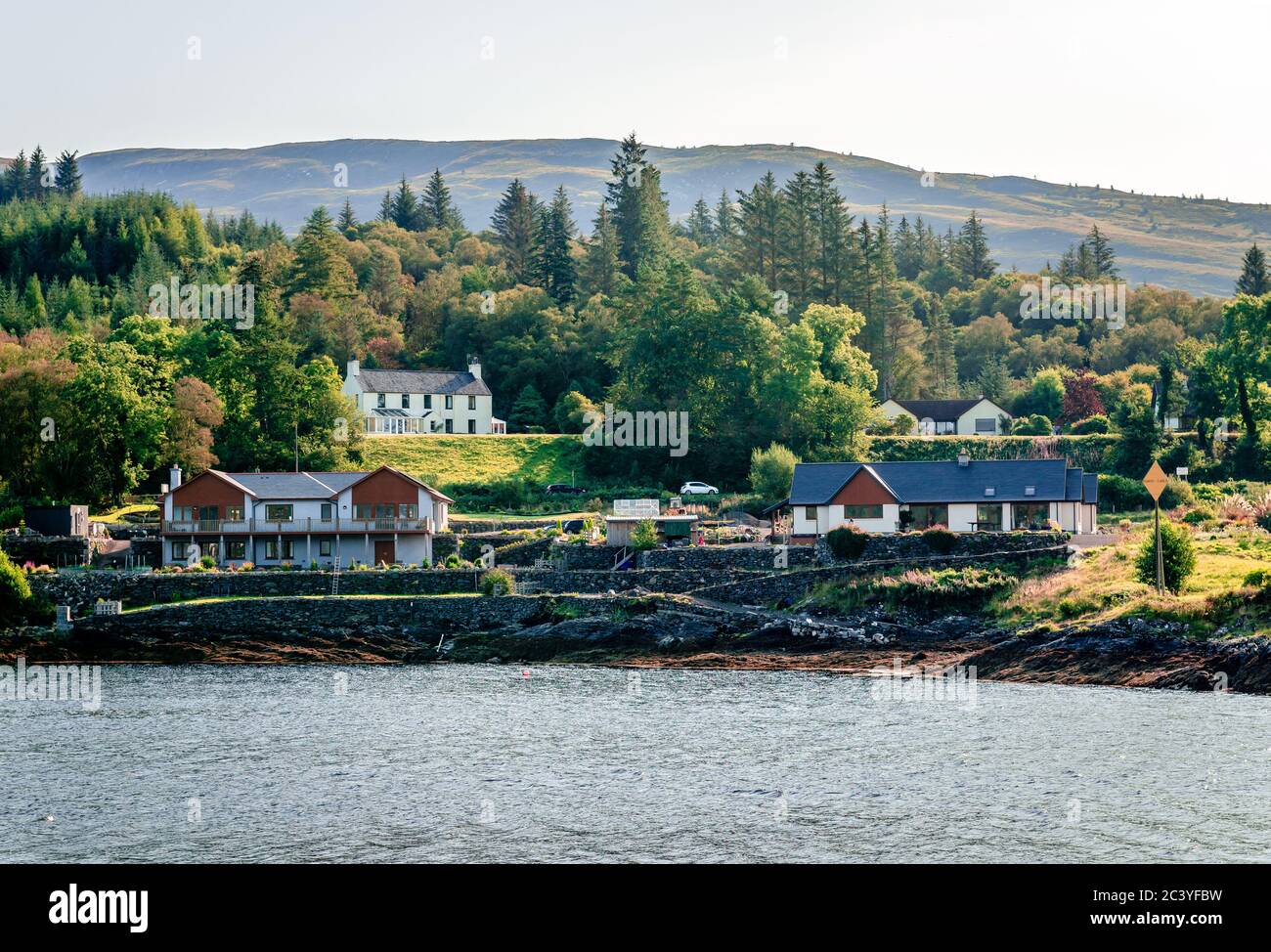 Cottages facing Loch Linnhe in Corran, a former fishing village on Corran Point, on the west side of the Corran Narrows of Loch Linnhe, in Scotland. Stock Photo