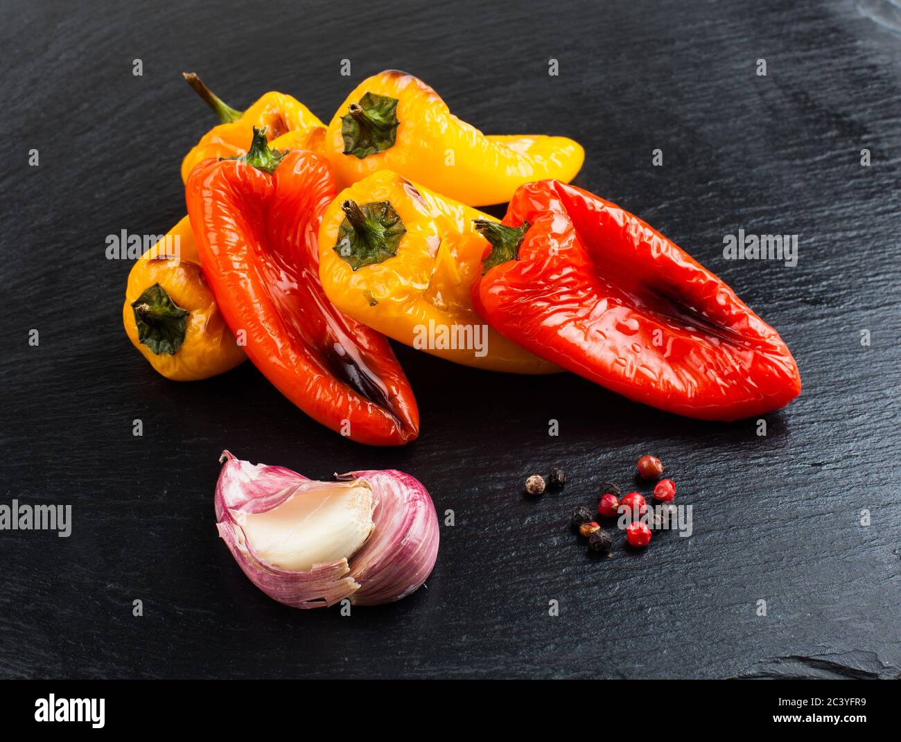 Red and yellow peppers grilled on olive oil Stock Photo - Alamy