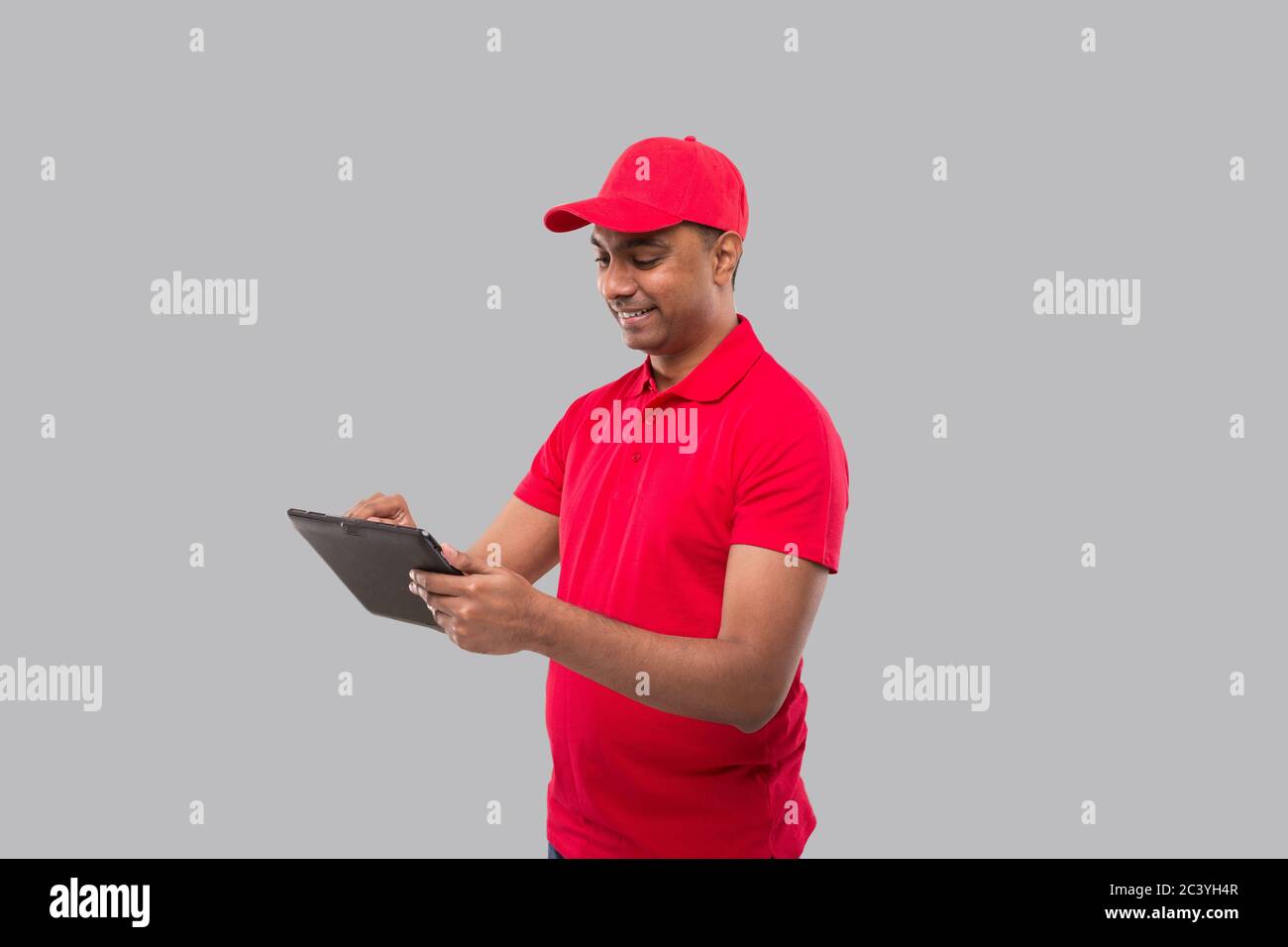 Delivery Man Using Tablet. Indian Delivery Boy with Tablet. Home ...