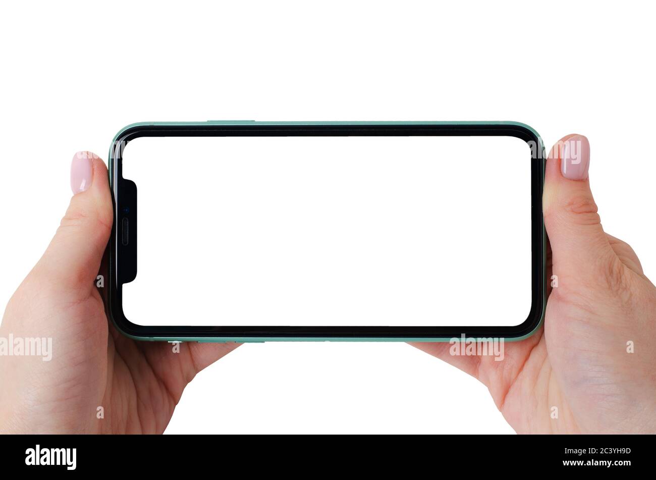 Moscow, Russia - January 18, 2020: Green Apple iPhone 11 mock up horizontal in a female hands isolated on a white background. Close-up of a new smartp Stock Photo