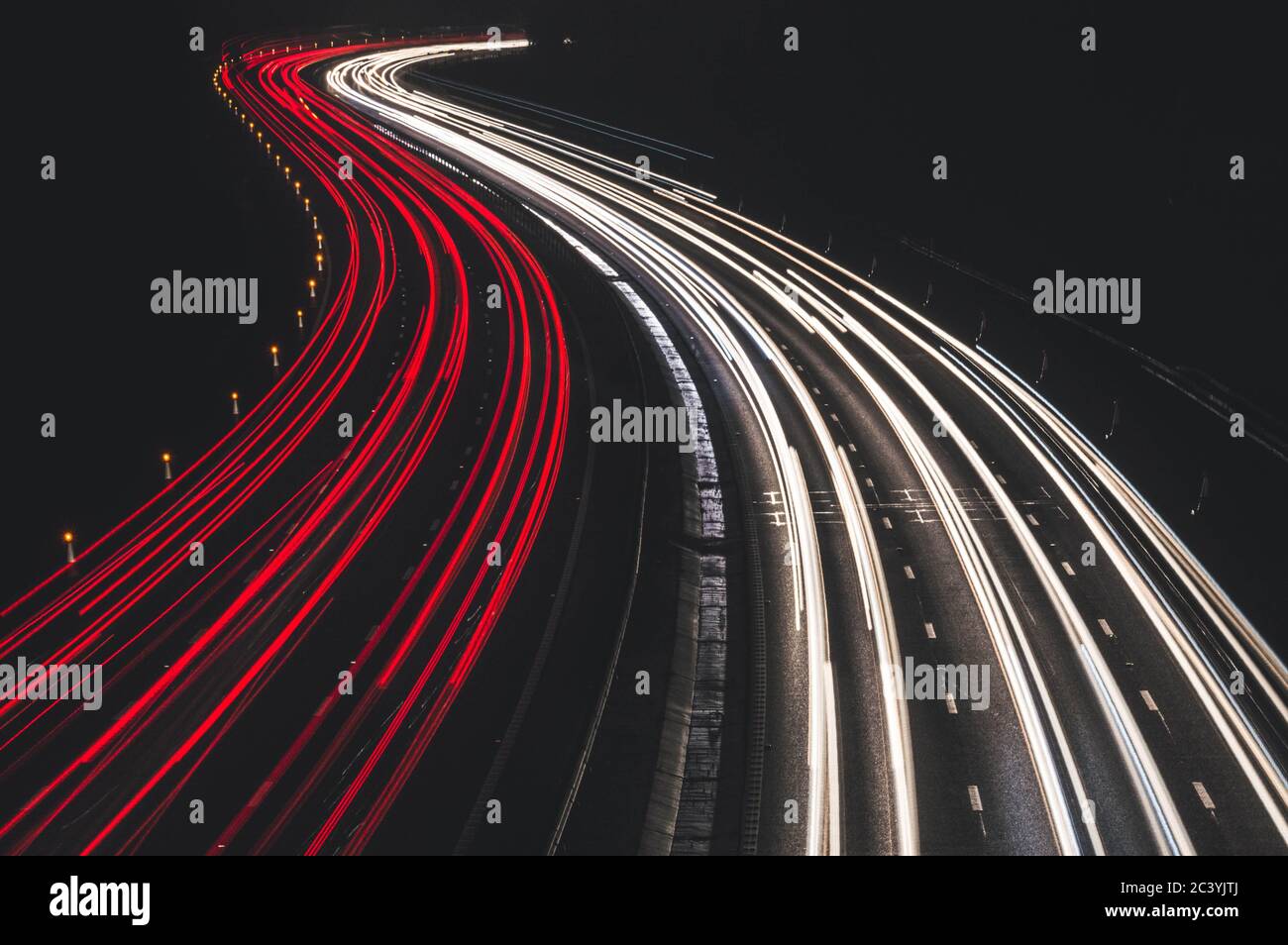 Light trails capturing the rush hour traffic on the M27, Hampshire. Stock Photo