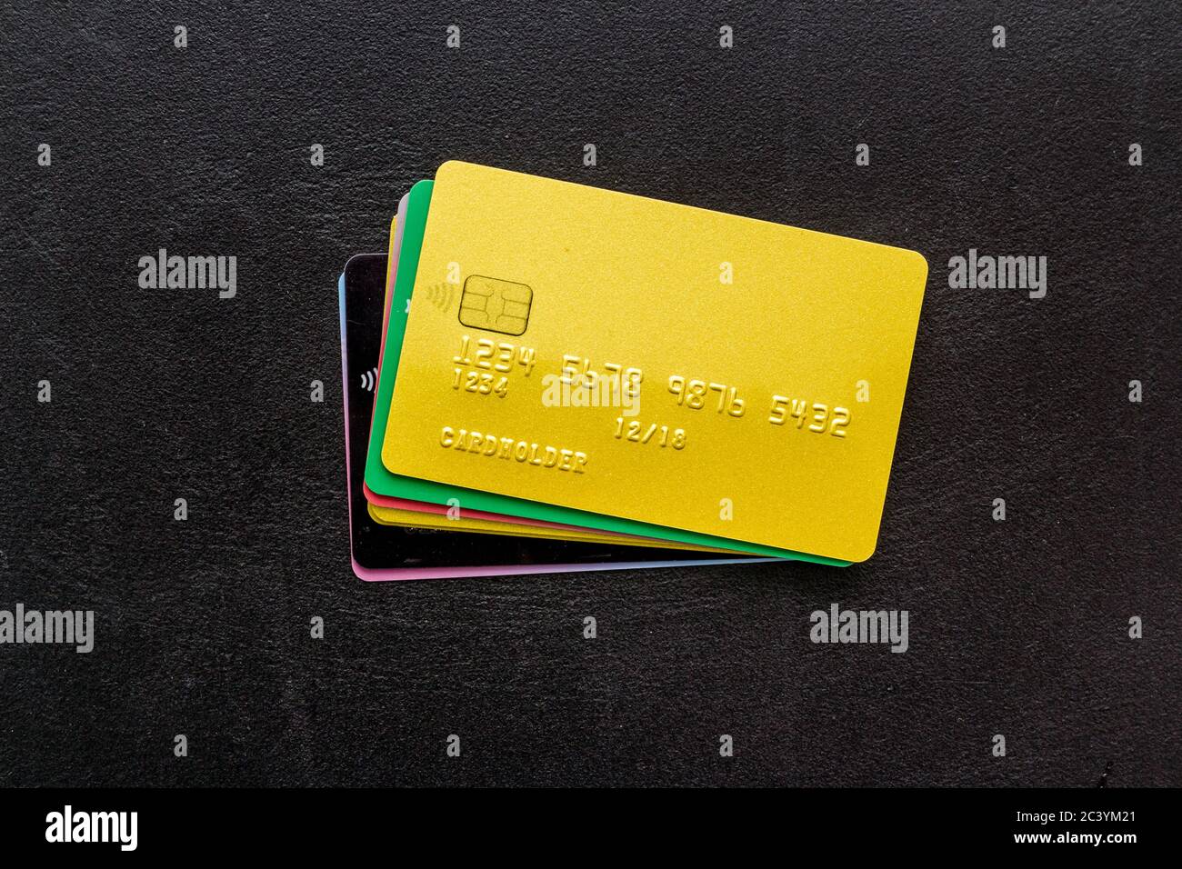security concept. stack of credit card on black desk top-down