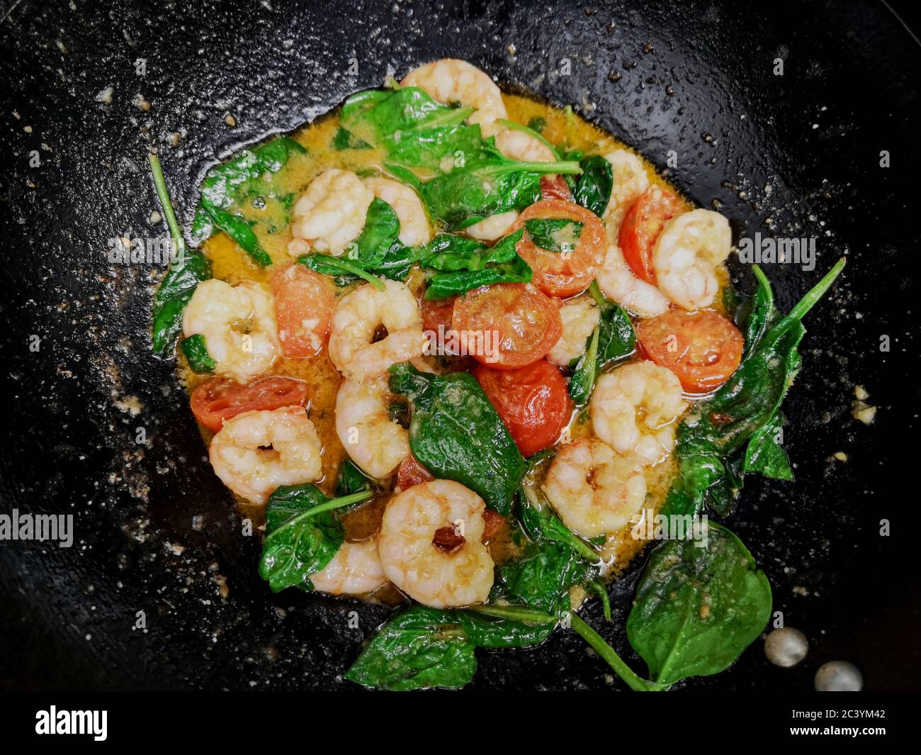 prawn stir fry in a black wok pan Stock Photo Alamy