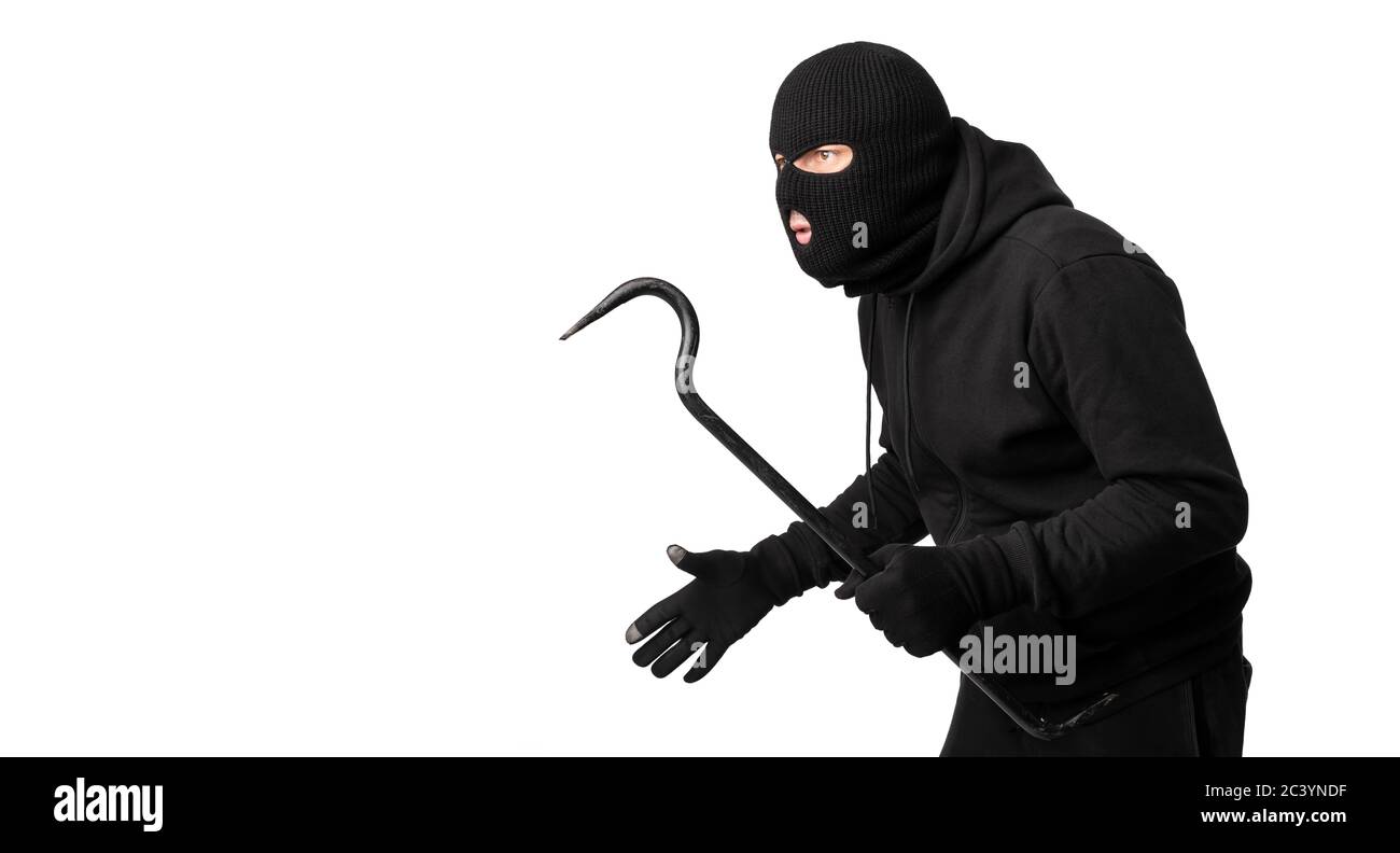 Thief wearing black mask and hoodie looking at copyspace Stock Photo