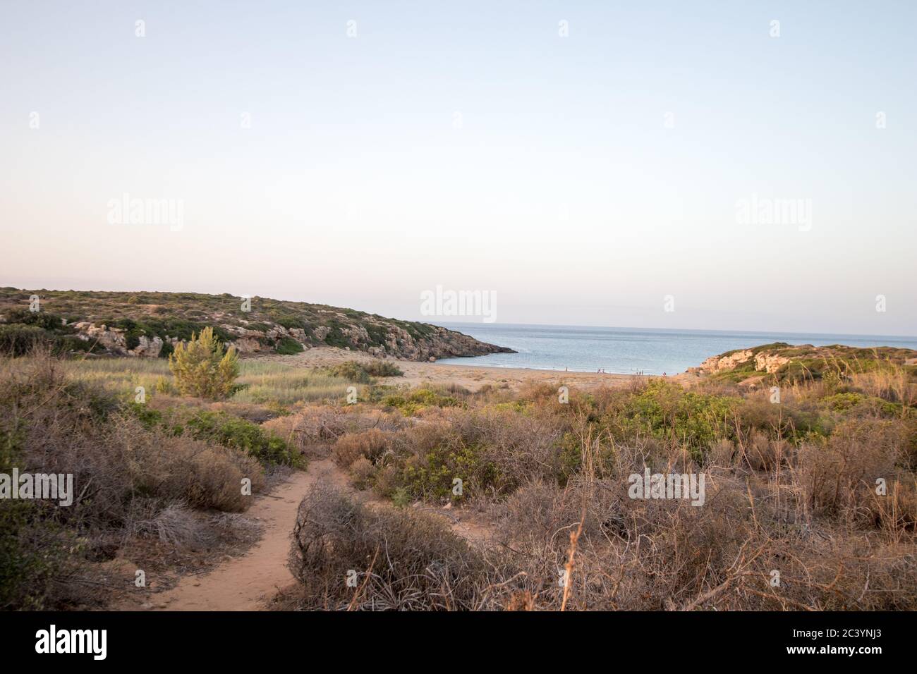 Calamosche beach at sunset view from hill with sand path Stock Photo
