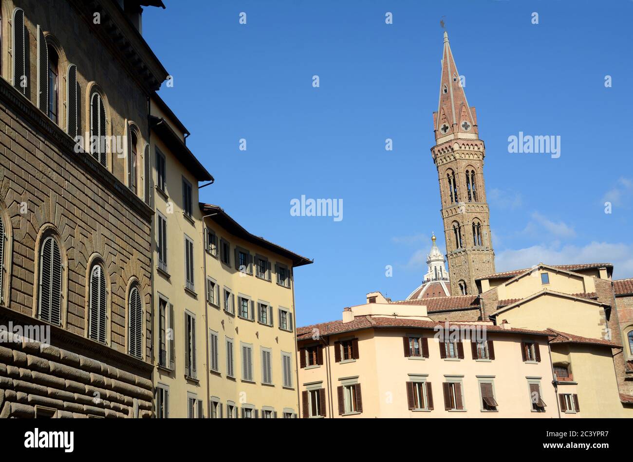The historic buildings of Piazza Santa Croce in Florence and in the background the tower of Arnolfo overlooking Palazzo Vecchio in Piazza della Signor Stock Photo