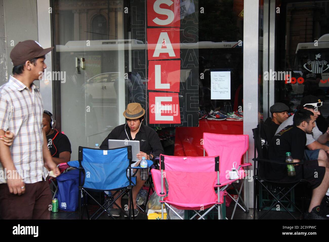 People begin queuing outside Foot Locker on George Street Sydney for the Nike Air Jordan 3 Lab 5’s. Some in the queue wear Air Jordan trainers. Stock Photo