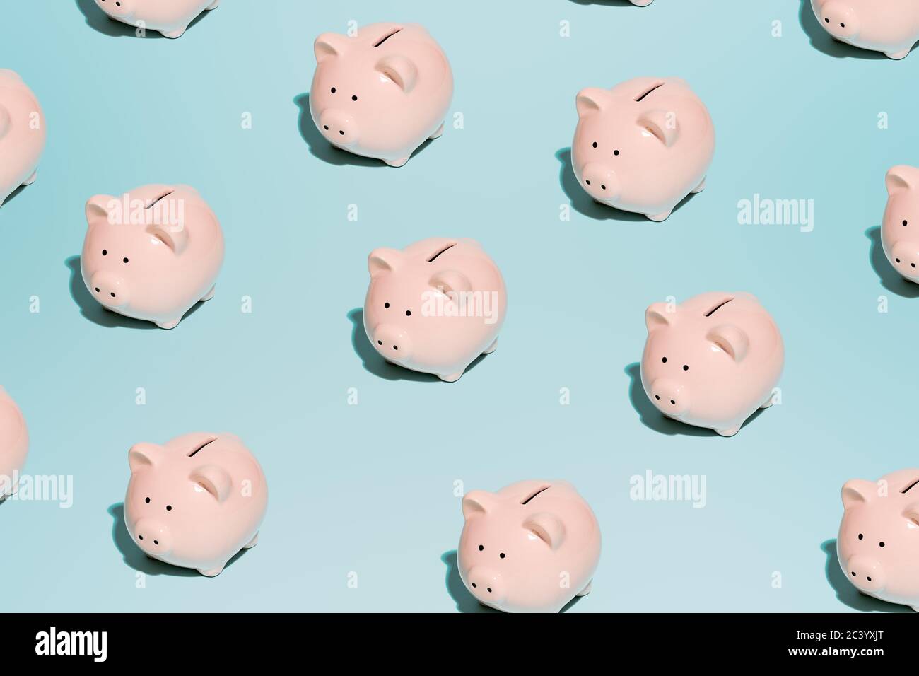 Pink piggy piggy banks on empty blue background Stock Photo Alamy