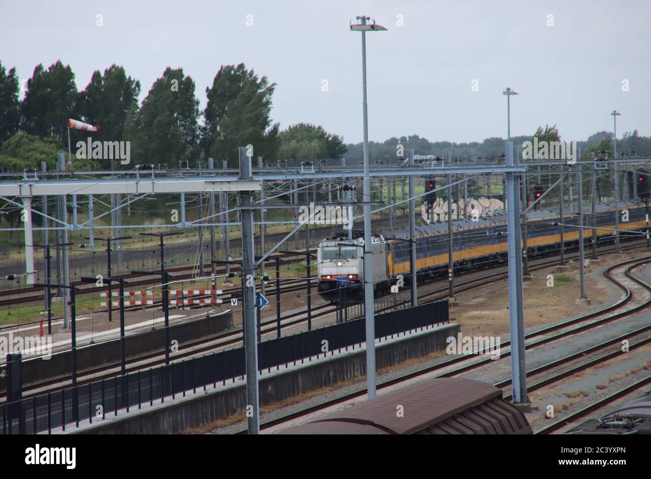 Intercity direct rushes along platform at poor train station Lage Zwaluwe in the Netherlands Stock Photo