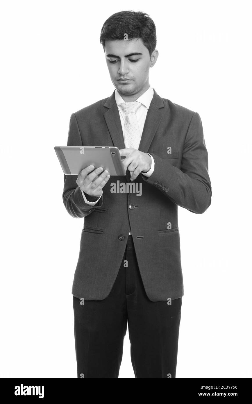 Young handsome Persian businessman using digital tablet Stock Photo