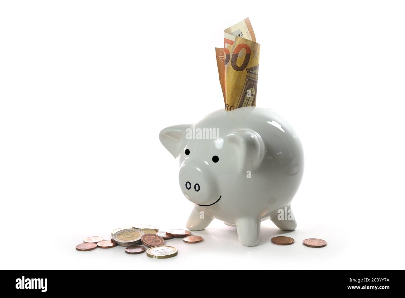 Lucky porcelain piggy bank with Euro bill and coins, isolated with small shadows on a white background, money concept for finance, economy and busines Stock Photo