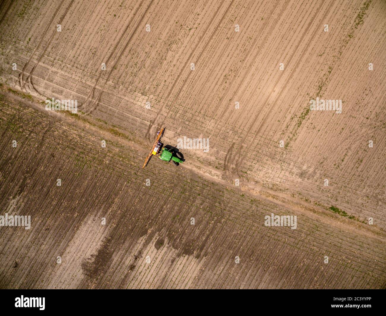 Aerial view on an agricultural crops sprayer in a field Stock Photo