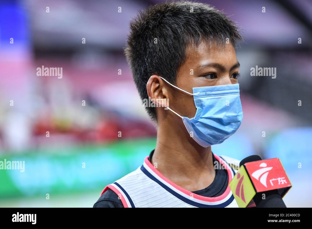 Zhang Jiacheng, an internet sensation, youth basketball player with one arm, is interviewed before a CBA game between Guangdong Southern Tigers and Shanxi Loongs, as he was invited to help the referees in a ceremonial tip off ceremony at the beginning of the game, Dongguan city, south China's Guangdong province, 20 June 2020. Stock Photo