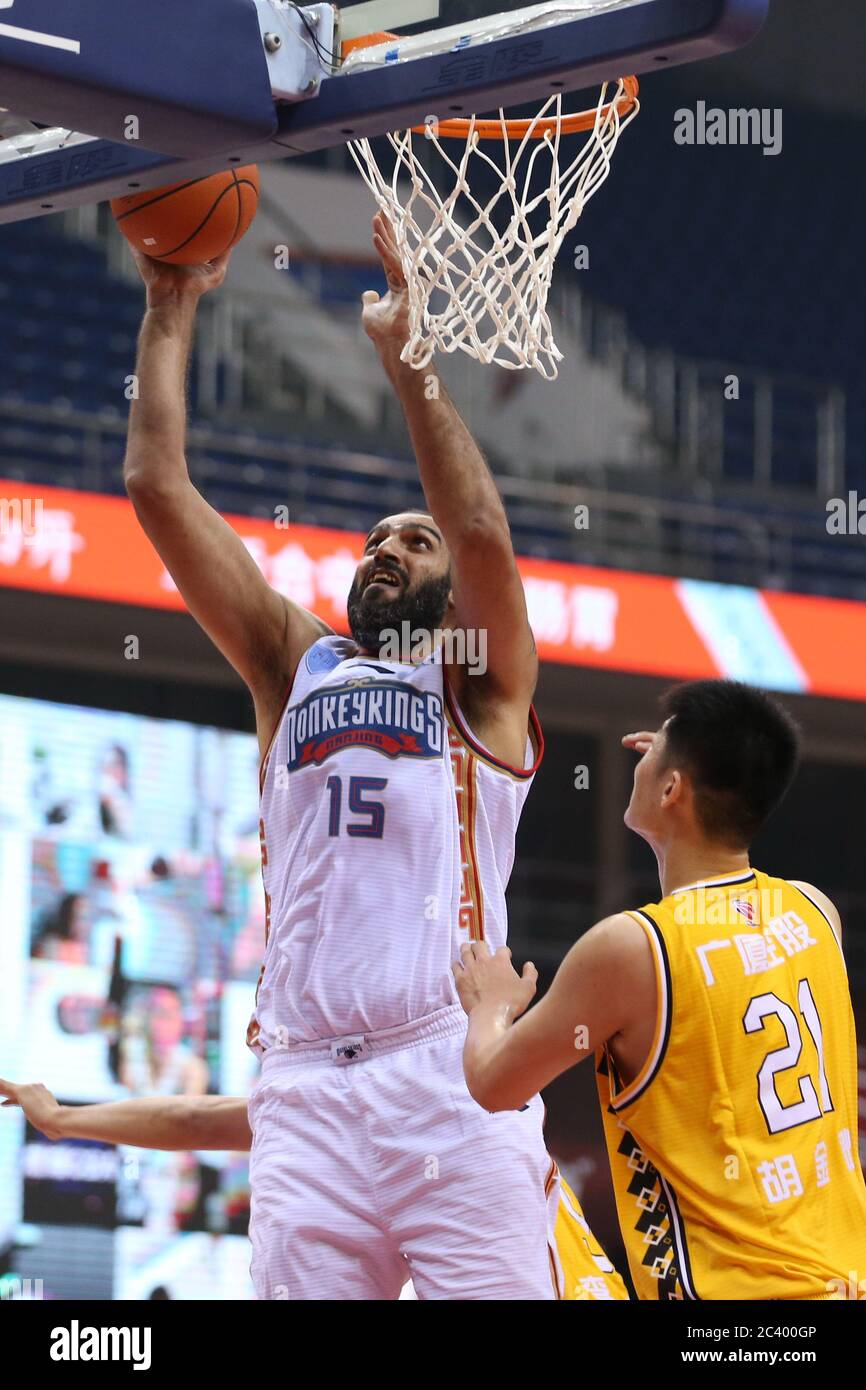 Iranian professional basketball player Hamed Haddadi of Nanjing Tongxi  Monkey King, left, makes a lay-up during a game at the first stage of  Chinese Basketball Association (CBA) resumption against Zhejiang Guangsha  Lions,