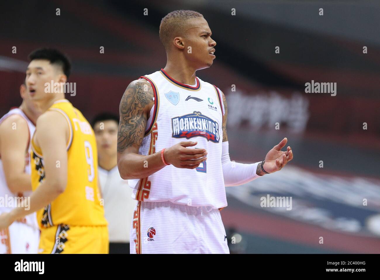 American professional basketball player Joseph Michael Young of Nanjing  Tongxi Monkey King, right, reacts during a game at the first stage of  Chinese Basketball Association (CBA) resumption against Zhejiang Guangsha  Lions, Qingdao