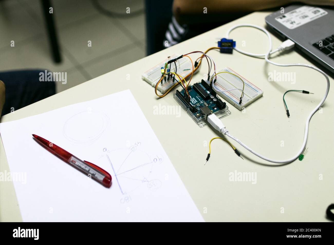 Circuit for a servomotor built for educational purposes. A programmed microcontroller manages the position of a servomotor, on a sheet are indicated t Stock Photo