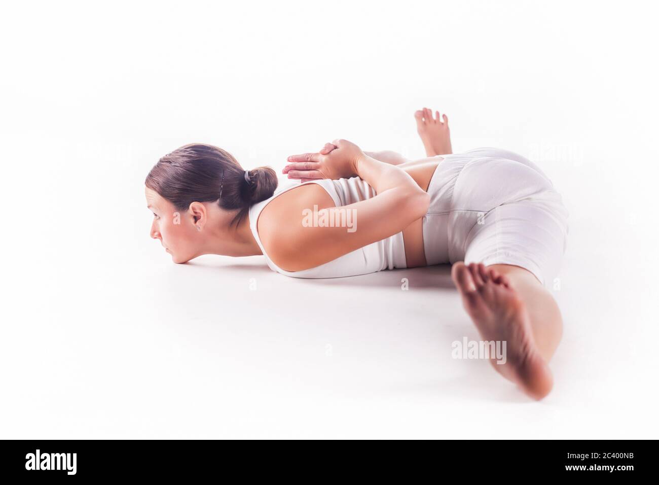 Woman practicing yoga doing the ' xWide Angle Seated Forward Bend ' posture. Upavistha konasana Stock Photo