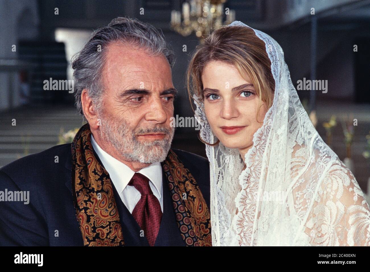 June 24th, 2002, Rinkenis, Denmark, Maximilian Schell and Rike Schmid at a press meeting for the ZDF series 'Der Furst und das Madchen'. Still picture as a newlyweds in the church of Rinkenis. M. Schell played the prince Friedrich von Thorwald, R. Schmid spelled Ursula Kaminski, née Countess von Lichtenthal, married by Thorwald. In 1962, Schell won the Oscar for Best Actor in 'The Judgment of Nurnberg'. Double portrait of the actor as a wedding couple. | usage worldwide Stock Photo