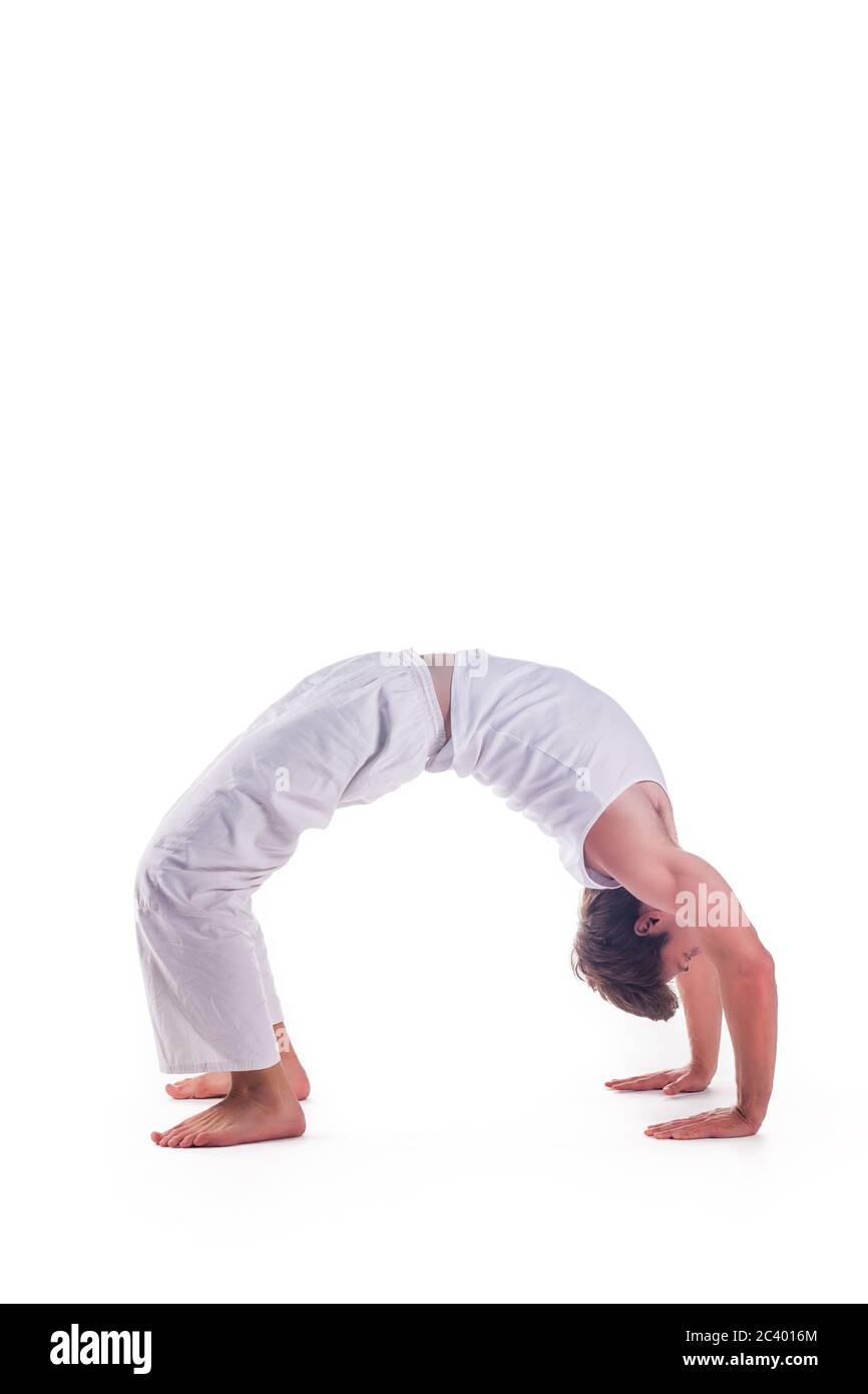 Man practicing yoga doing the ' Upward Bow ' posture. Urdhva Dhanurasana Stock Photo