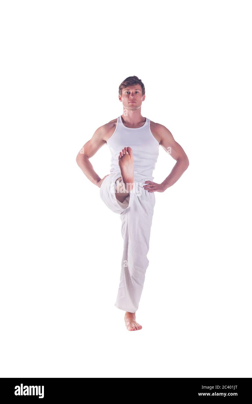 Young Fit Woman Doing a Yoga Pose Standing with One Leg Raised Up