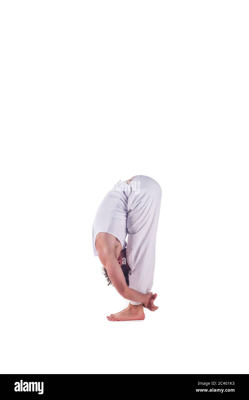 Man practicing yoga doing the  Standing Forward Bend  posture