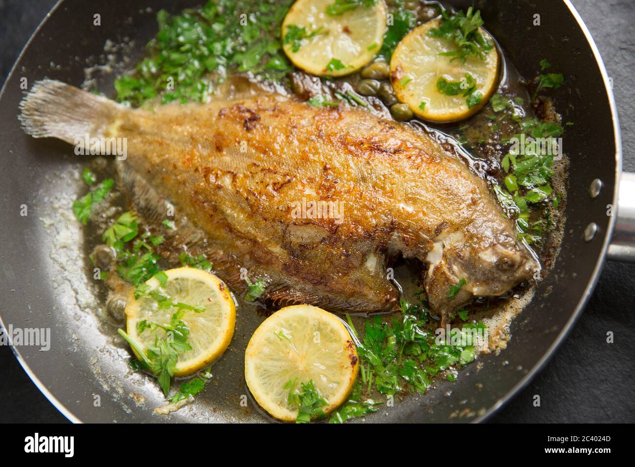 A home cooked whole lemon sole, Microstomus kitt, that has been pan fried in butter with lemon