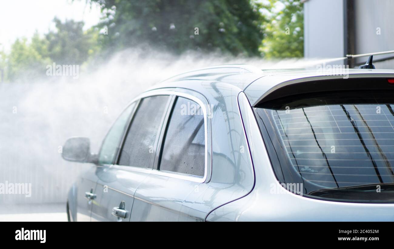 Water splash under the pressure. Wash the car at selfservice service