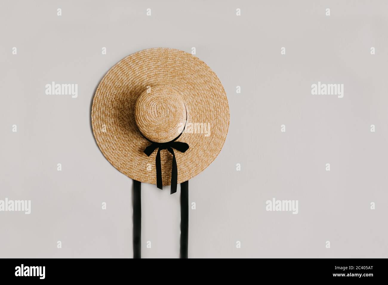A straw hat with a black ribbon isolated. Stock Photo