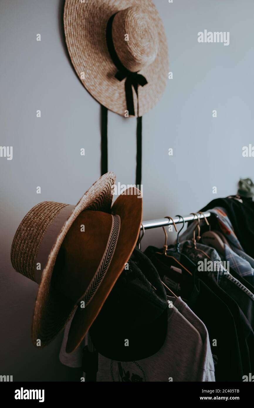 Clothes hanger with hats. Stock Photo