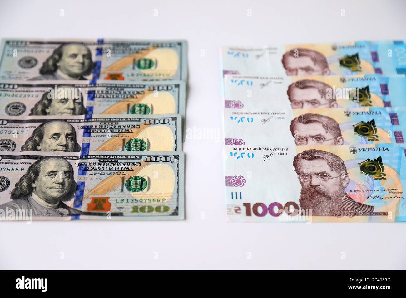 Ukrainian hryvnia, new banknotes of 1000 hryvnias and American 100 dollar bills, close-up. Money background, concept of gifts, shopping, Ukraine, USA Stock Photo