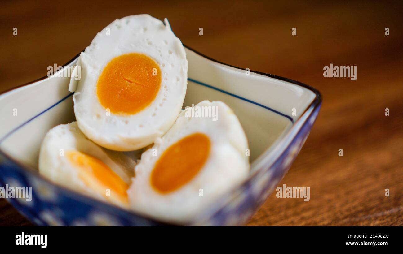 A salted duck egg is a Chinese preserved food product made by soaking duck eggs in brine, or packing each egg in damp, salted charcoal. Salted duck eg Stock Photo