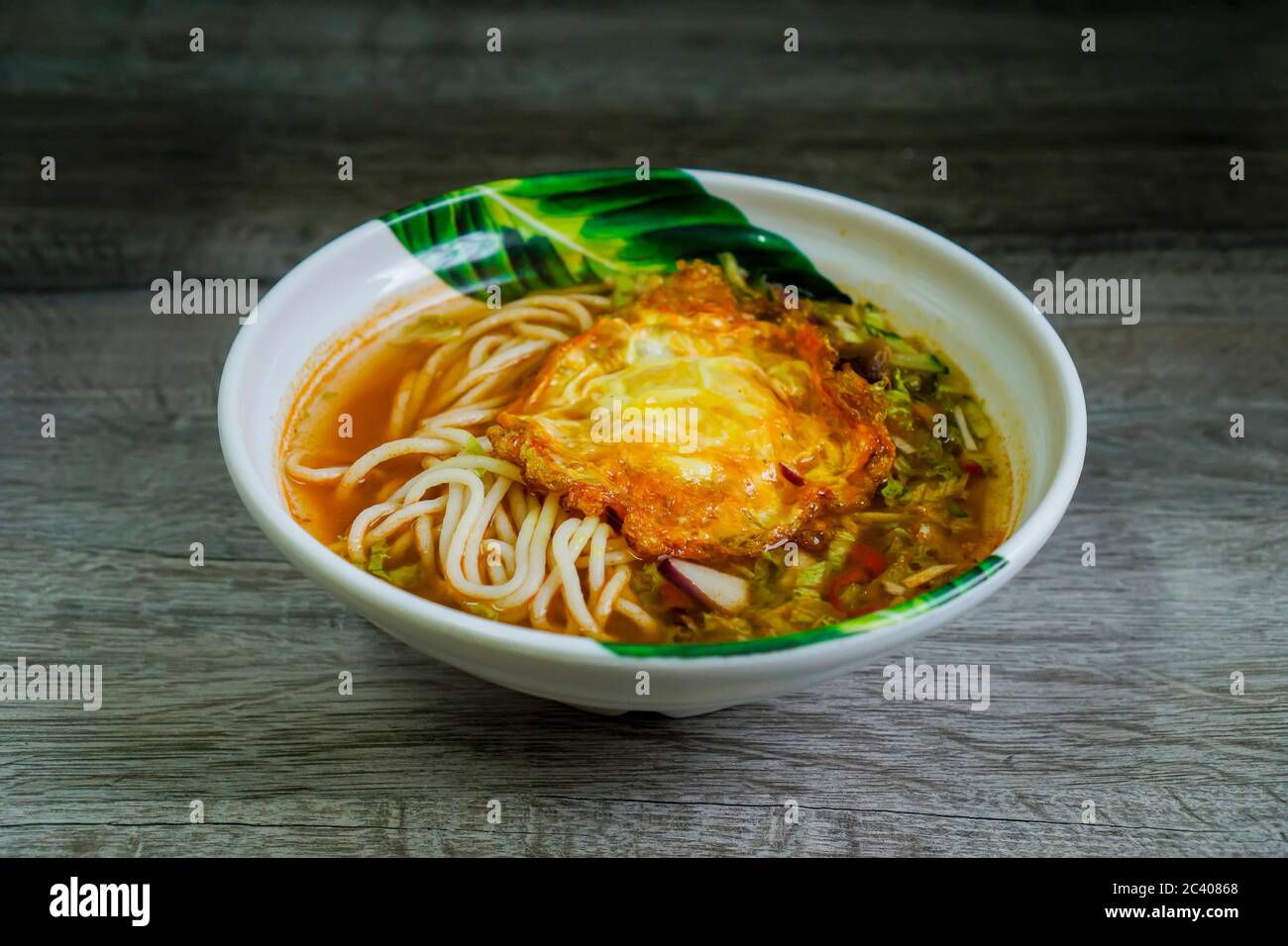 Traditional laksa from nothern Malaysia with a little twist. Serve with fried egg instead of boiled egg. Stock Photo