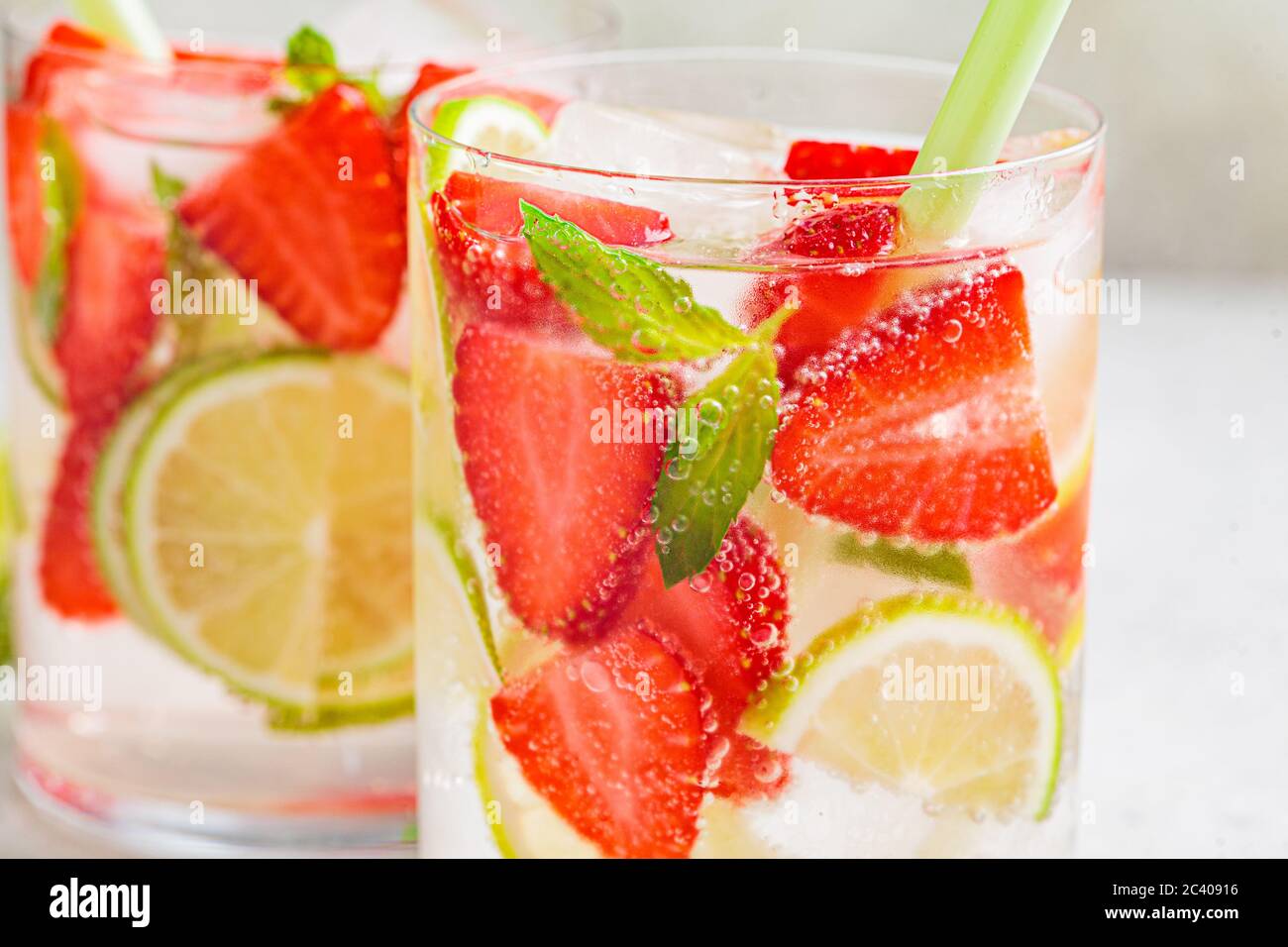 Detox sassy water with strawberry and lime in glasses. Healthy eating concept. Stock Photo