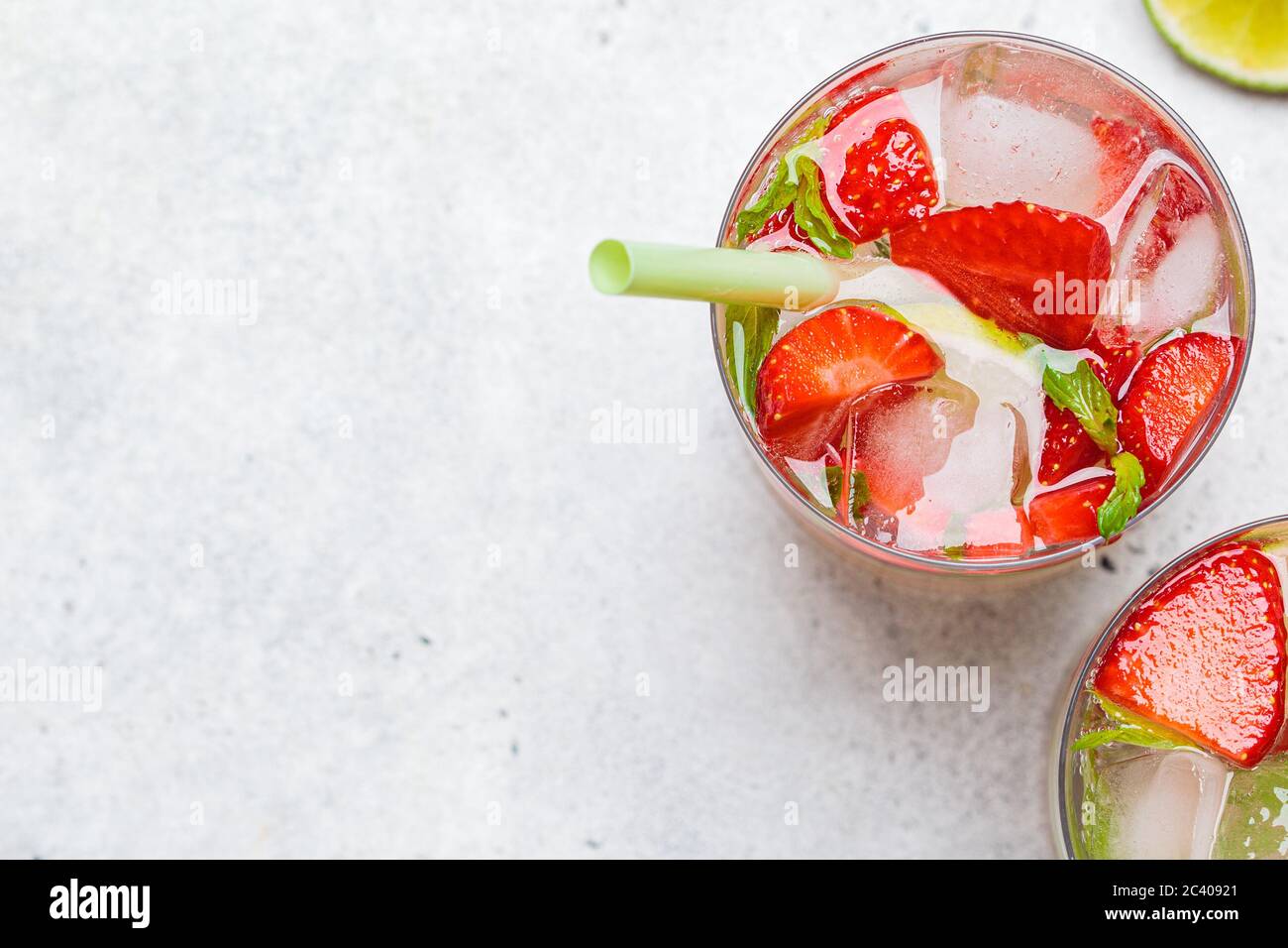Detox sassy water with strawberry and lime in glasses. Healthy eating concept. Stock Photo