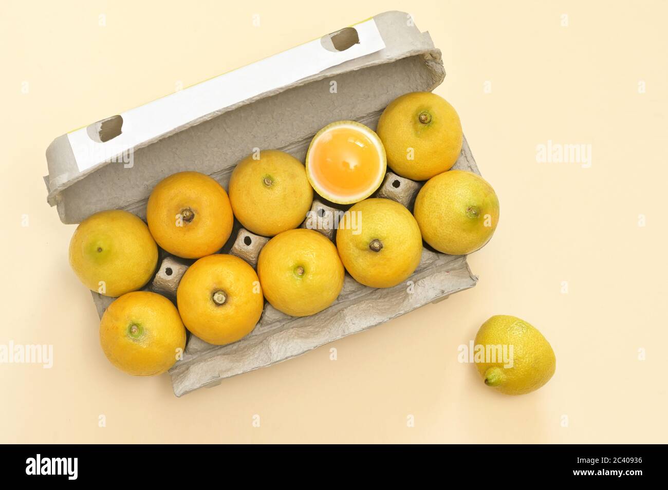 Conceptual Lemon Dozen Chicken Eggs In A Package One Egg Is Open Stock Photo