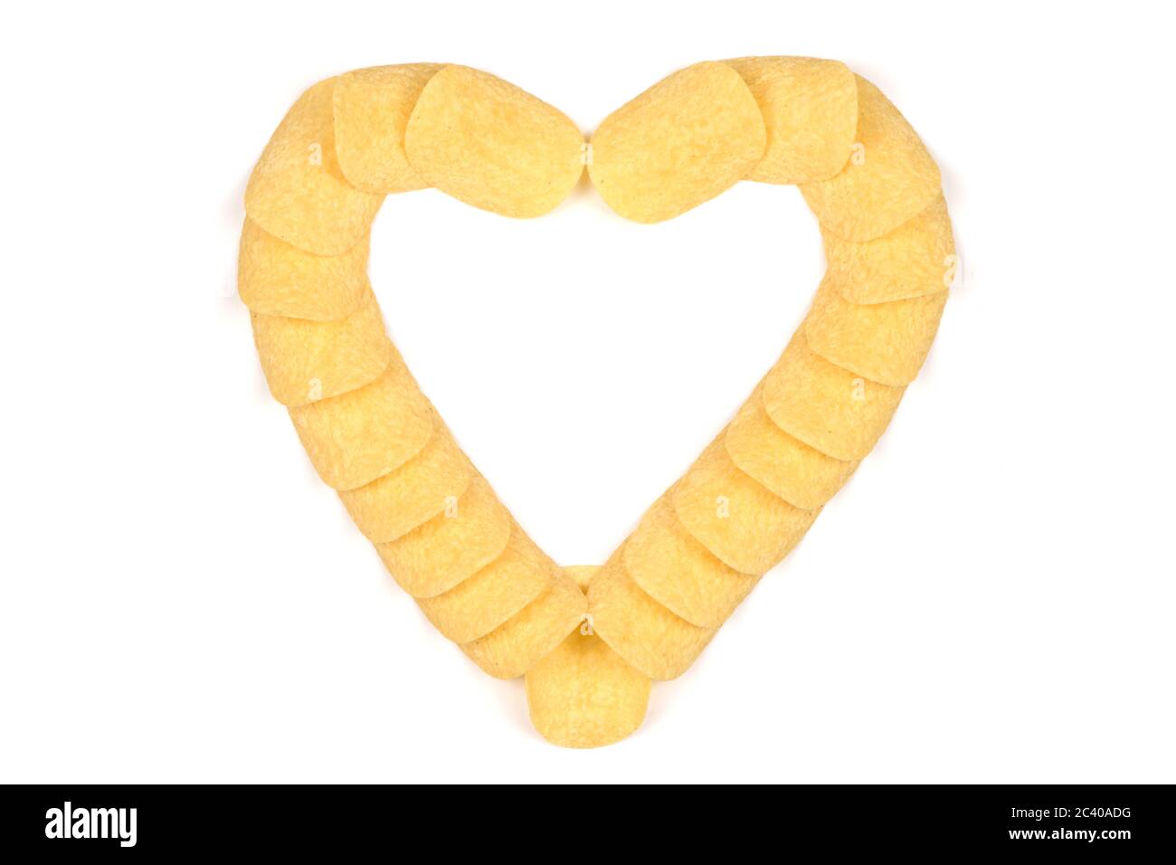 Tasty crispy potato chips in heart shape isolated on white background