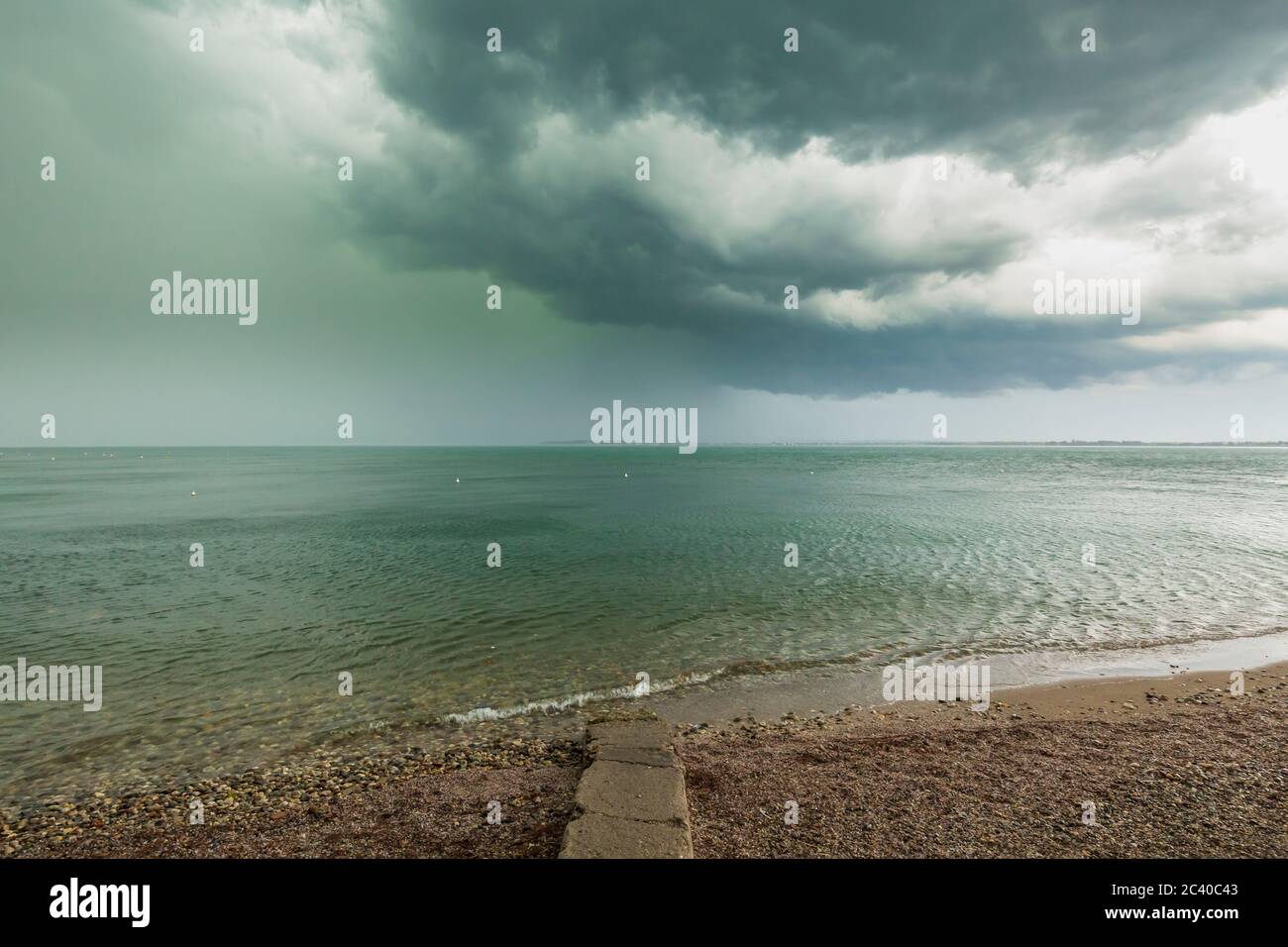 Severe weather with thunderstorms, heavy rain showers and strong winds develop rapidly at Desenzano del Garda city, lake Garda, Brescia, Lombardy, Ita Stock Photo