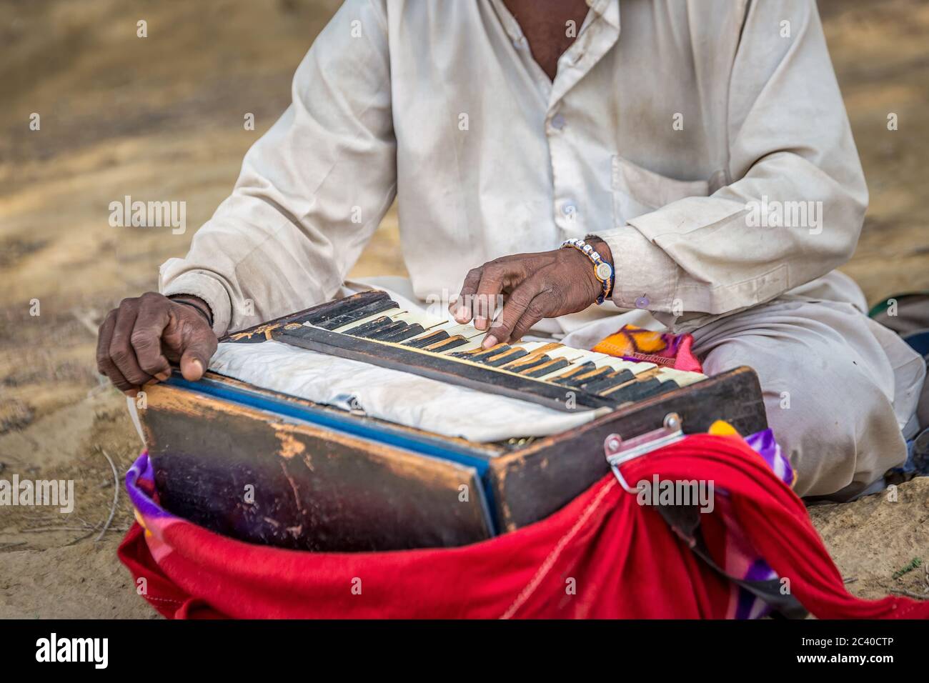 A old man is playing indian traditional musical instruments for kirtan harmonium. Stock Photo