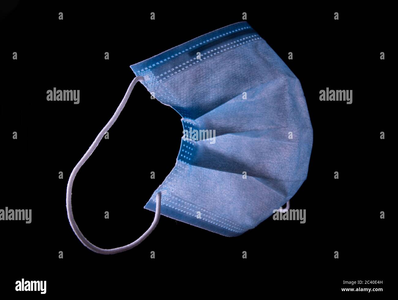 Simple blue standard surgical mask isolated on black Stock Photo Alamy